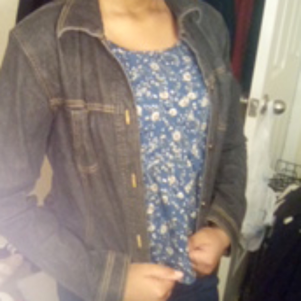 A collard dark blue jean jacket with buttons